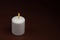 One whiteÂ candleÂ flameÂ burningÂ onÂ dark backgroundÂ withÂ copyÂ space forÂ text